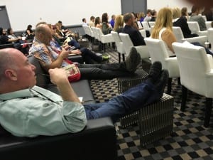 Attendees kick back and take notes from couches and lounge chairs in session rooms. Nice.