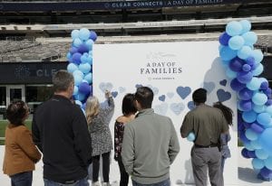 Clear Day of Families 2021_4 families sign a wall of hearts