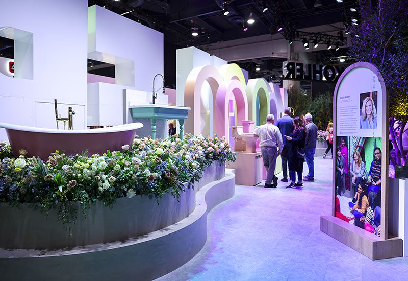 Kohler's booth with bathtubs, toilets and greenery