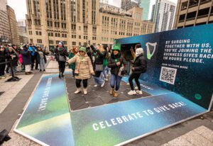 uinness-stpatsday-2023-women dancing-in green-hats