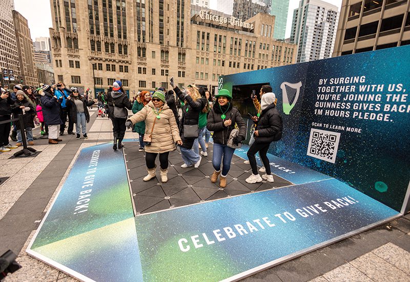 uinness-stpatsday-2023-women dancing-in green-hats