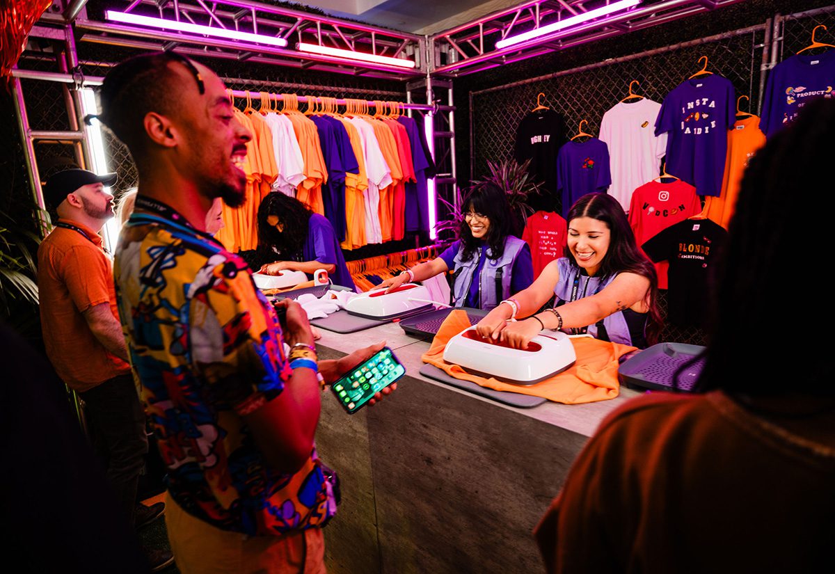 Attendee interacts with the DIY t-shirt station.