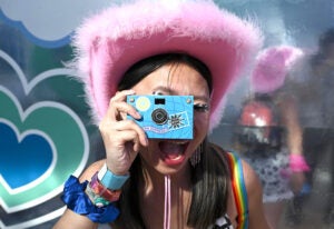 amex-coachella-2023-retro-photo-lab girl taking photo-festival-activation-credit-ap