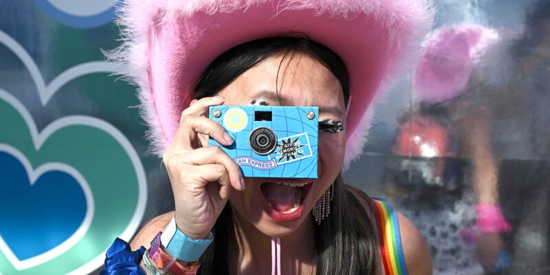 amex-coachella-2023-retro-photo-lab girl taking photo-festival-activation-credit-ap