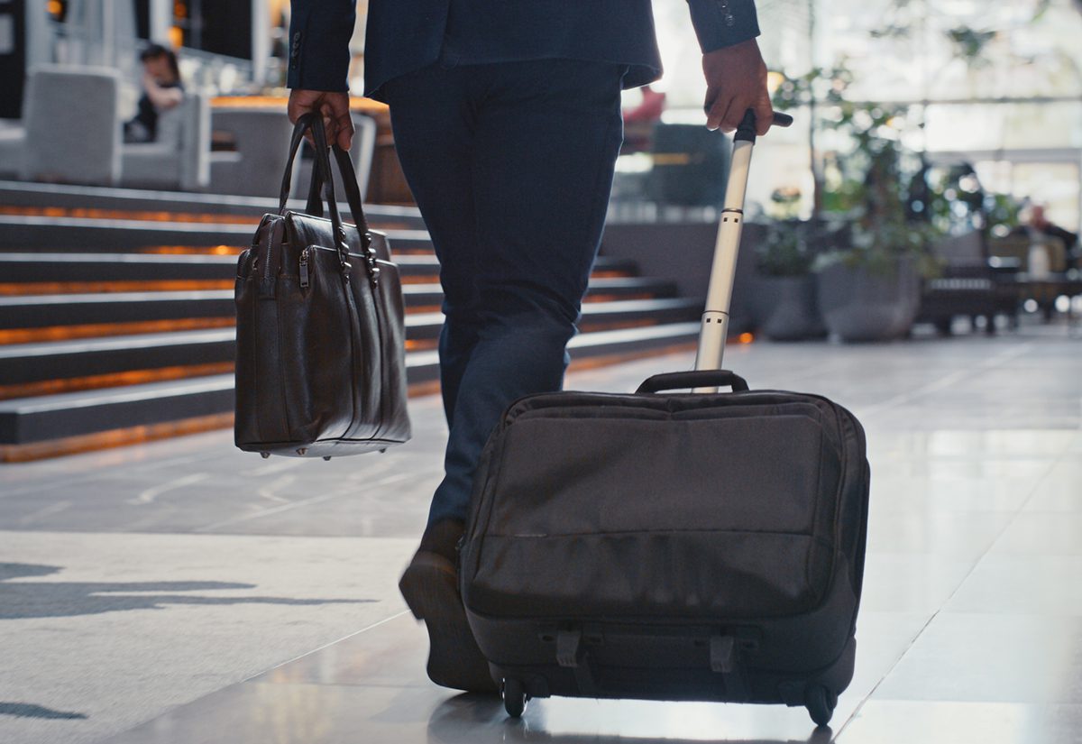 istock-business-traveler-airport-suitcase