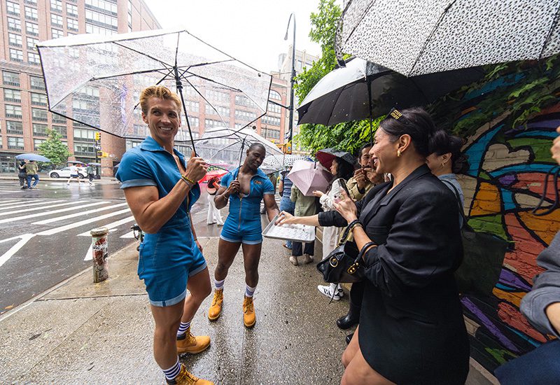 Hot Fellas offer samples to fans in the rain